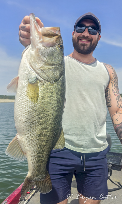 A smiling angler with a big trophy Texas largemouth bass