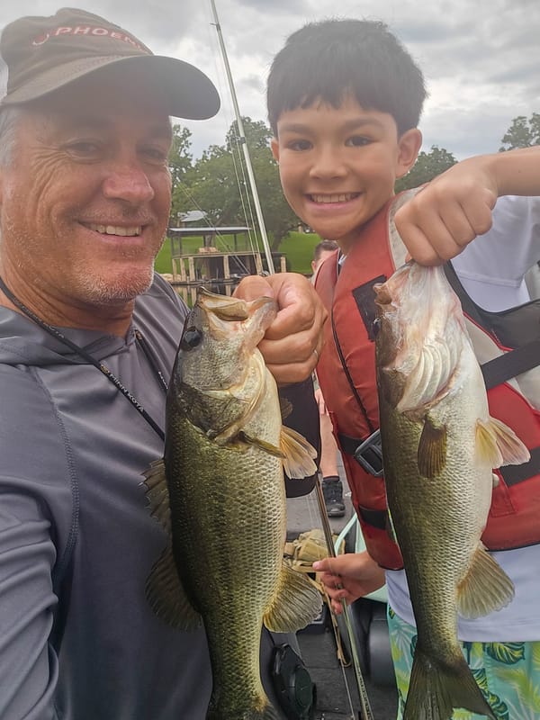 Guide and young angler doubled up with two largemouth bass on Lake Austin