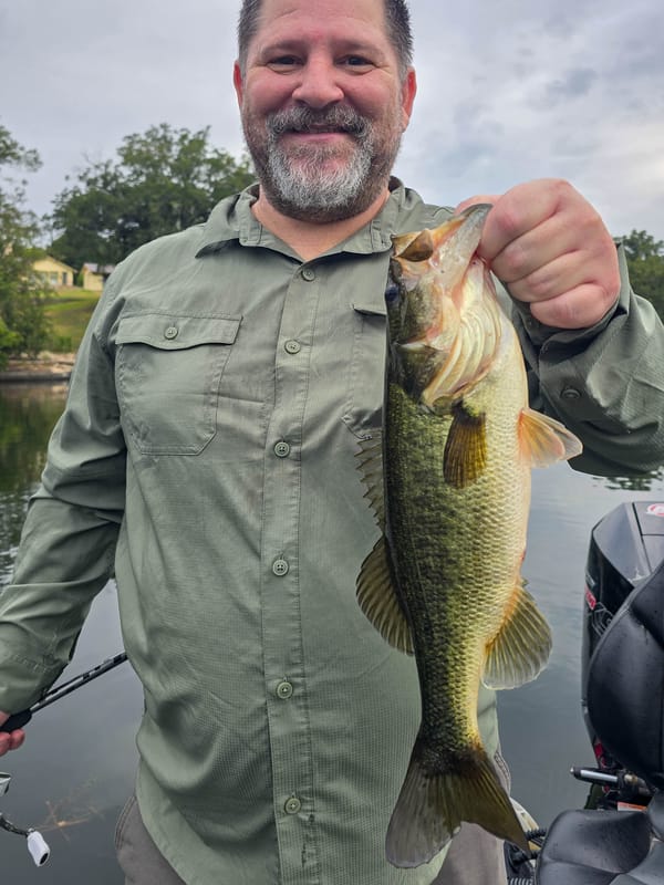 Angler with a quality largemouth bass from a Lake Austin guided trip
