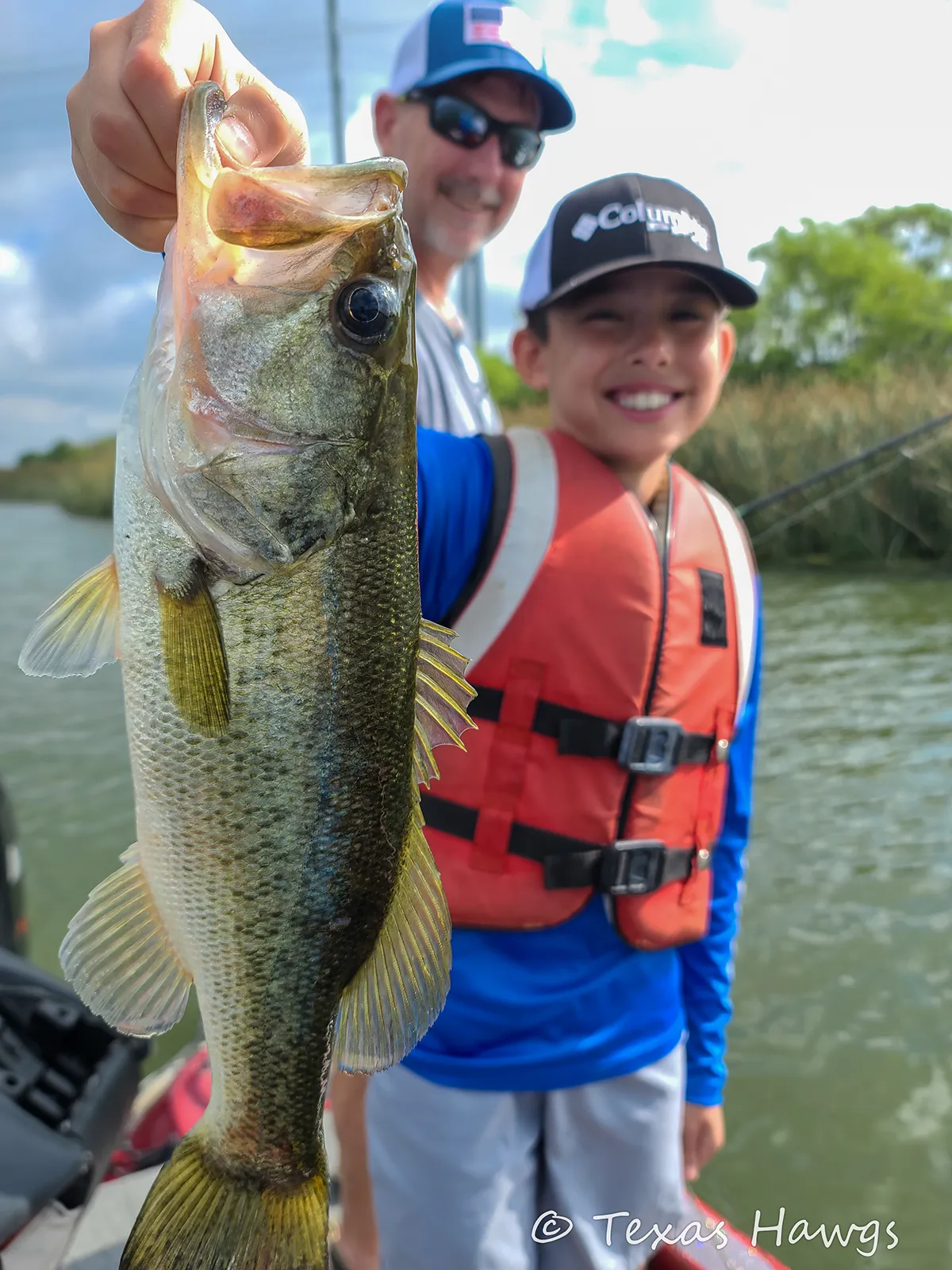 A father and son fishing together in the boat on a Texas Hawgs guided trip